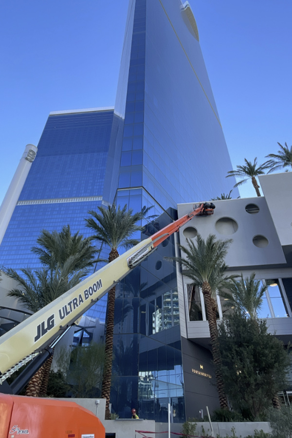 Exterior of the Fontaine Bleau in Las Vegas. A large machine is seen working on the building.